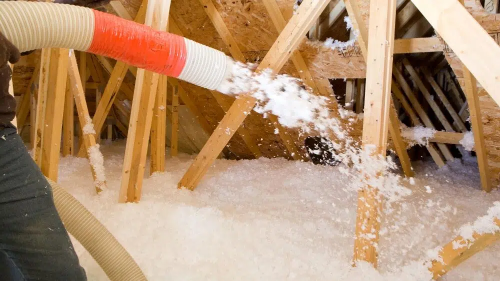An attic under renovation with wood framing and blown-in insulation in progress in West Hollywood, CA.