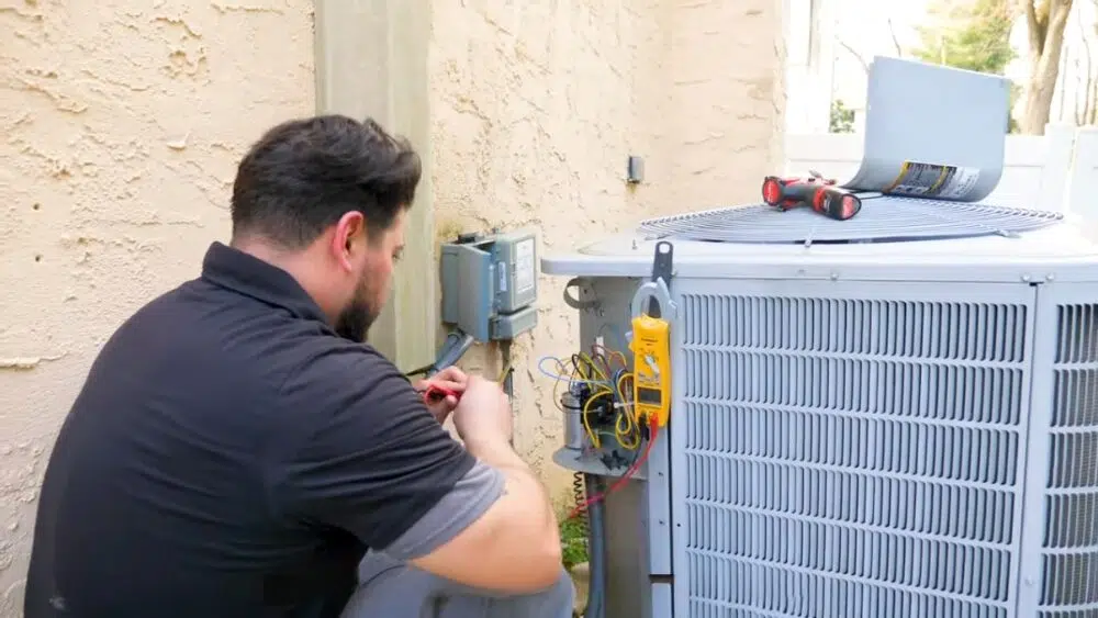 An affordable heating and air professional performing diagnostic tests on outdoor units during commercial AC maintenance in West Hollywood.