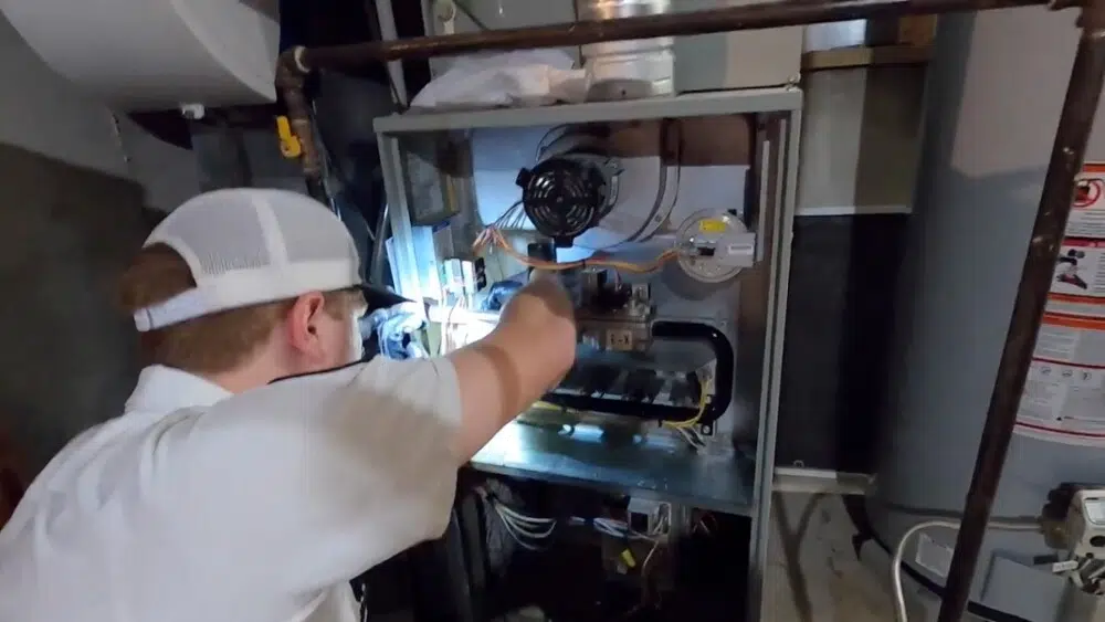 An Affordable Heating and Air technician inspects indoor AC unit components during a routine AC check-up in West Hollywood.