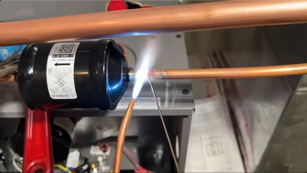 Closeup of refrigerant line being repaired during emergency HVAC service in Santa Clarita, CA.