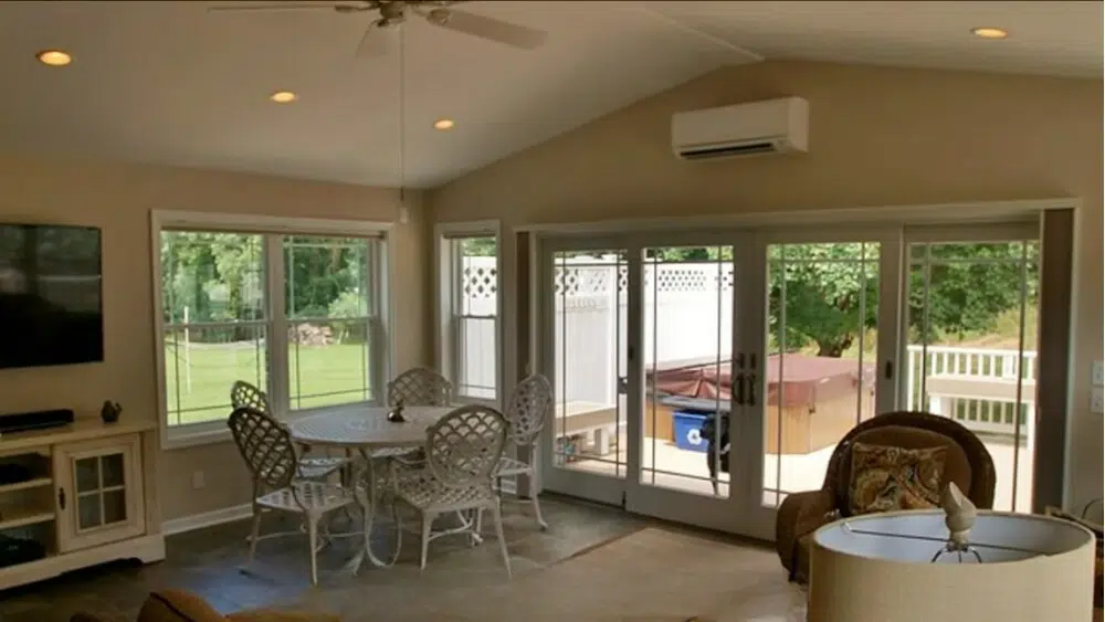 Energy efficient AC installation in a Beverly Hills living room with large windows and sliding doors.