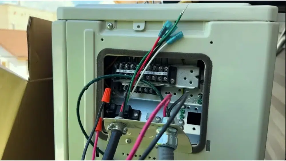 Affordable Heating and Air, a leading HVAC contractor in Beverly Hills working on the electrical panel of an HVAC unit.