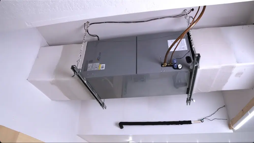 Newly installed air handler unit suspended from ceiling by Affordable Heating and Air in Santa Clarita, CA.