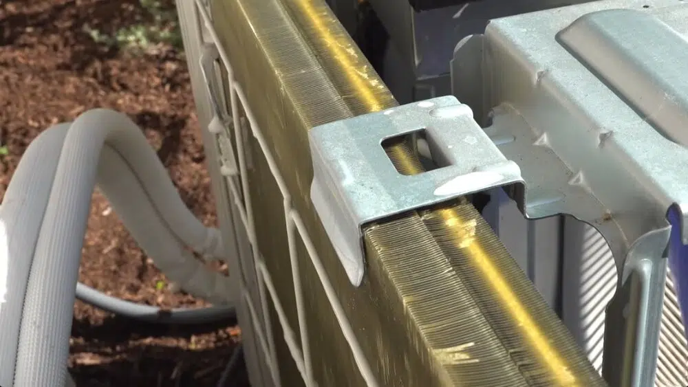 Close-up view of an HVAC outdoor unit coil being inspected during routine maintenance in Los Angeles County, CA.
