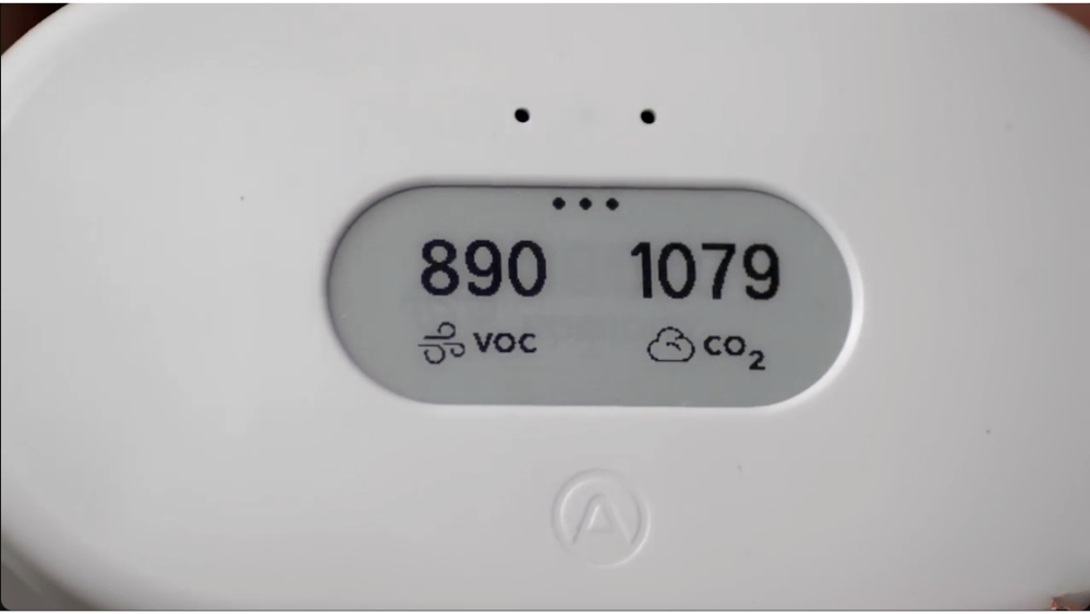An advanced air quality monitor displaying VOC and CO2 levels, essential for indoor air quality testing.