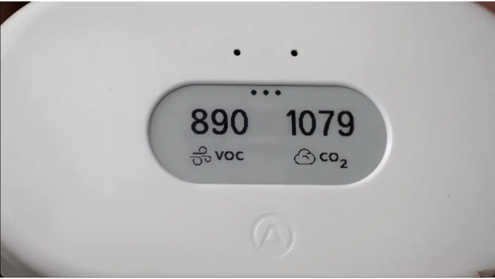 An advanced air quality monitor displaying VOC and CO2 levels, essential for indoor air quality testing.