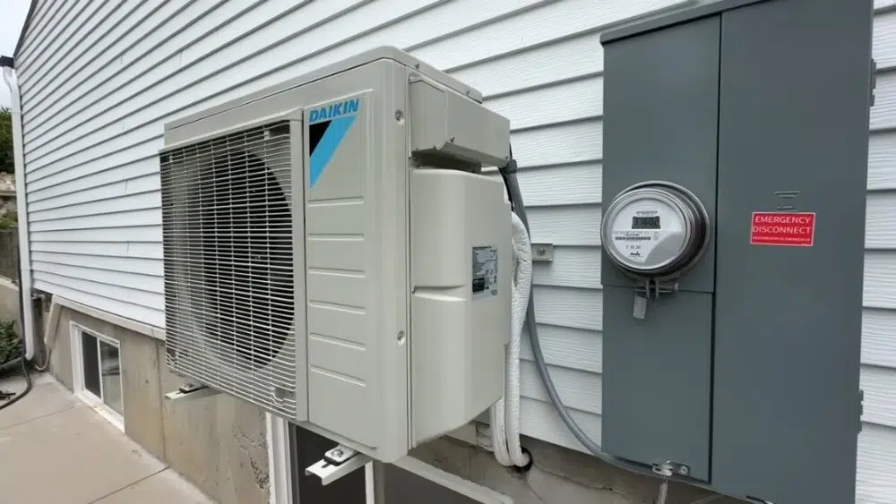 Outdoor Daikin mini split AC unit installed next to a home in Santa Clarita, CA, with electrical connections.