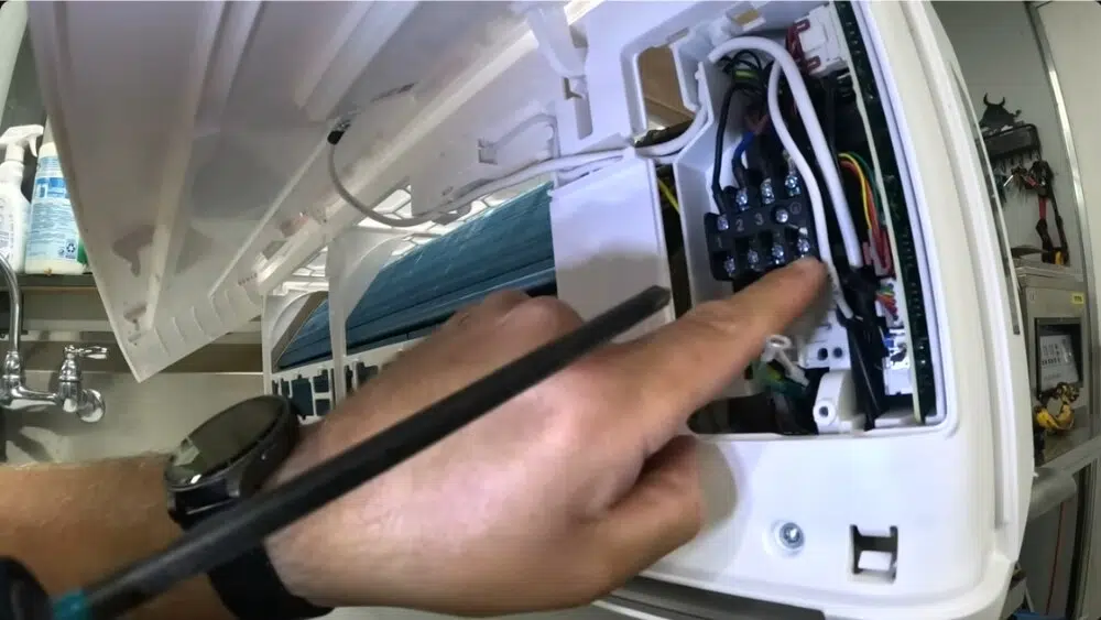 Affordable Heating and Air technician connects a wire during a mini-split installation in Santa Monica, CA.