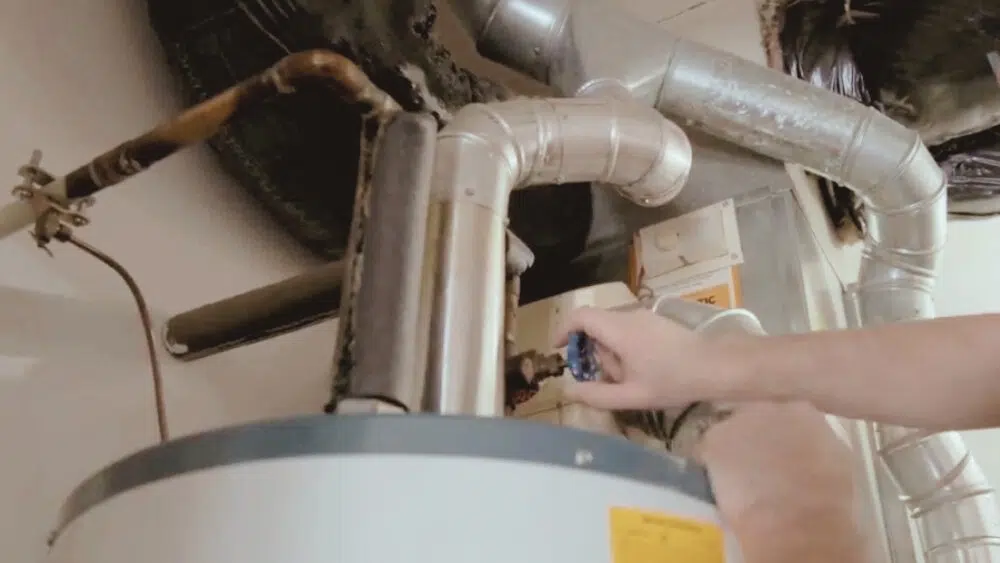 Technician performing urgent heating repair on a water heater, part of emergency HVAC service in Santa Monica.