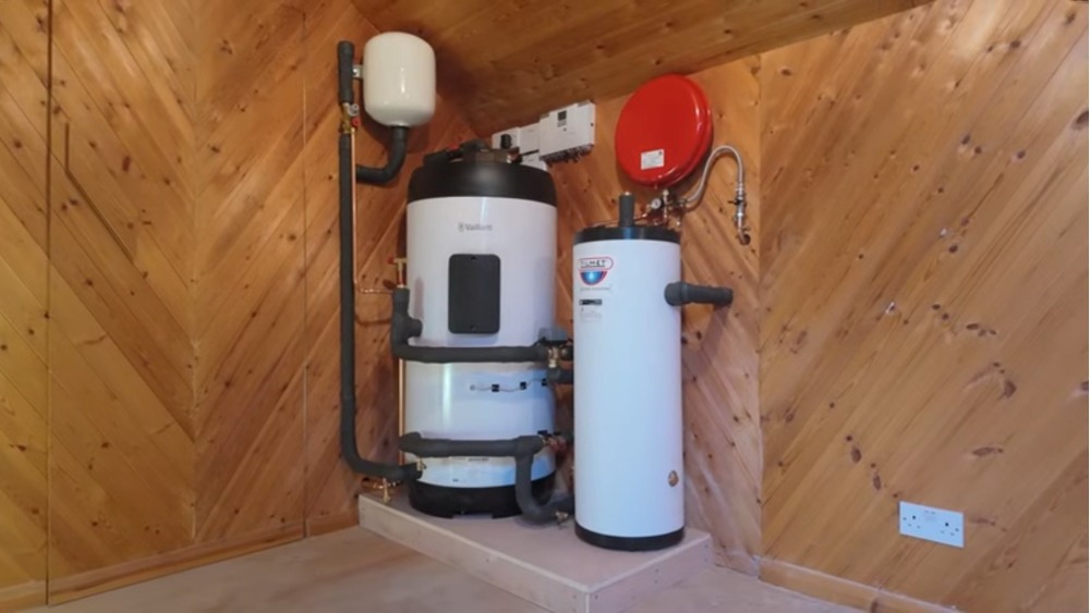 Heat pump contractors Santa Clarita CA attic installation showing heat pump system with expansion tank in wooden utility space