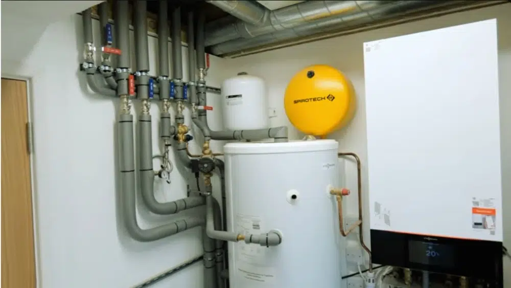 Heat pump services Santa Clarita CA utility room showing hot water tank and heating system components