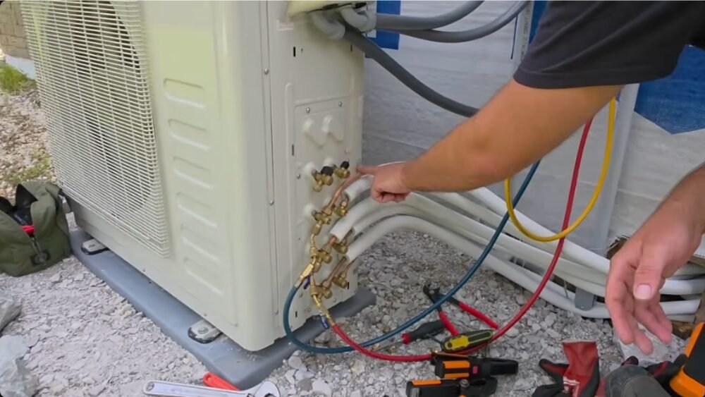 Technician checking refrigerant lines of a multi-zone mini split system during installation in Santa Monica, CA.