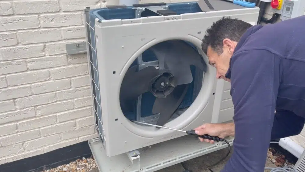 Technician repairing and servicing an outdoor heat pump, part of expert heat pump service and repair in Santa Monica, CA.