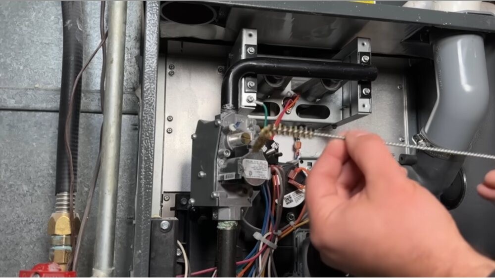 Technician performing furnace tune-up with burner and ignition cleaning in Los Angeles County.