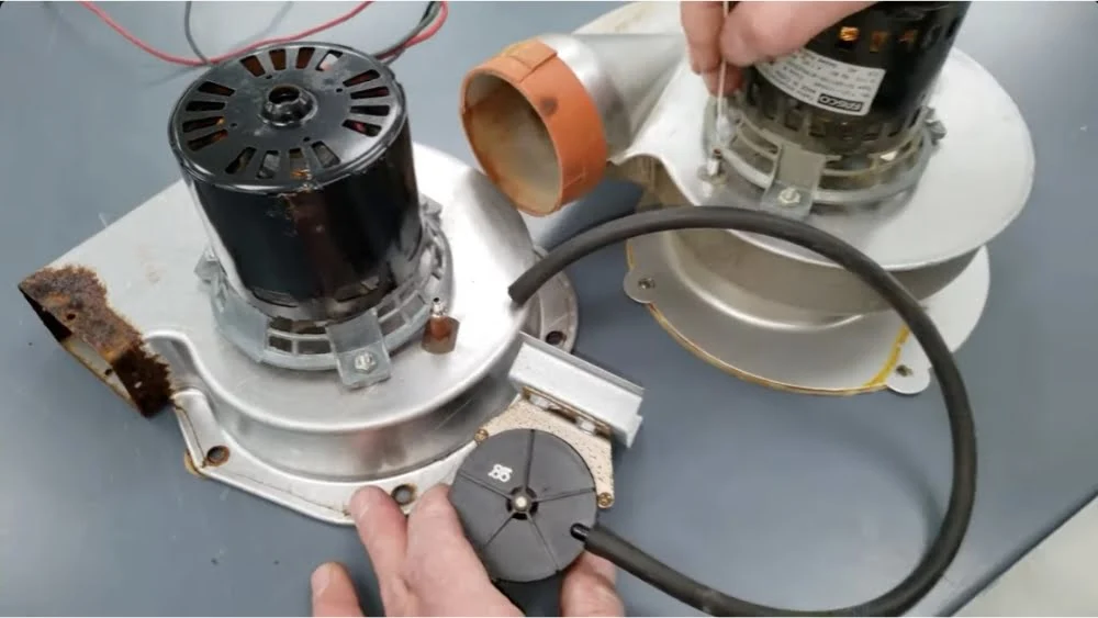 HVAC technician performing furnace tune-up in Santa Monica inspecting motor assembly and blower components during heating system maintenance.