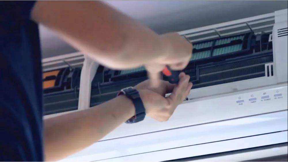 AC repair technician using tools for same day air conditioning repair in Agoura Hills, California.