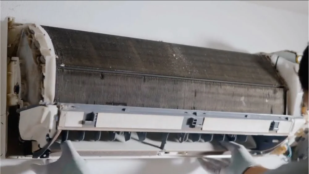 Technician performing emergency AC repair and cleaning service for a residential unit in Agoura Hills, CA.