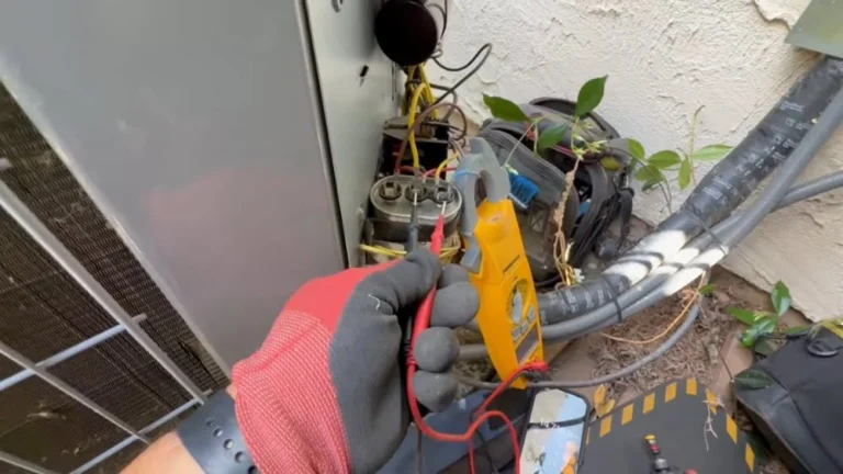 Technician testing an outdoor AC unit capacitor for Air Conditioner Repair Simi Valley.