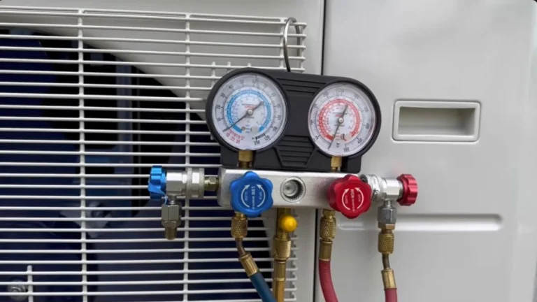 HVAC manifold gauges connected to an outdoor unit during heat pump installation in Thousand Oaks.