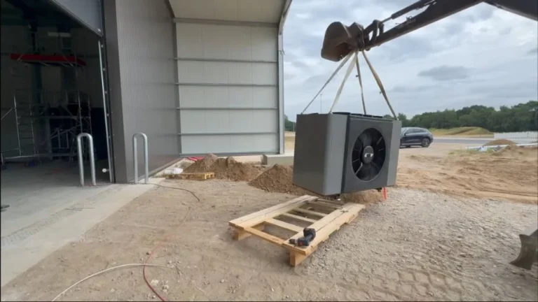 Large outdoor heat pump being lifted into position for an electric heat pump installation project in Simi Valley.