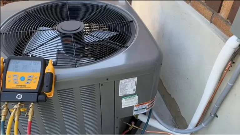 Fieldpiece manifold gauges checking pressures on outdoor condenser during central air conditioner replacement.