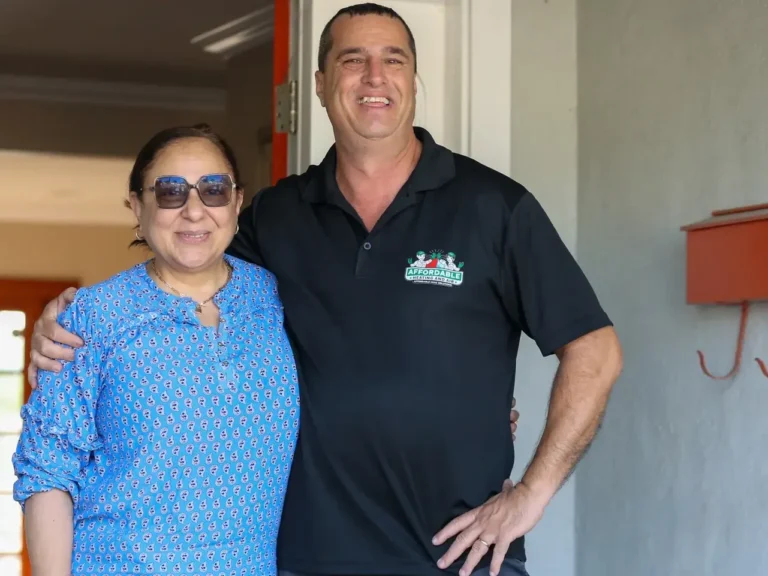 Happy California homeowner with an Affordable Heating and Air technician after an energy-efficient HVAC upgrade.