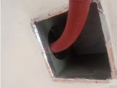 Vacuum hose inserted into a return vent boot during duct cleaning and inspection in Van Nuys CA.