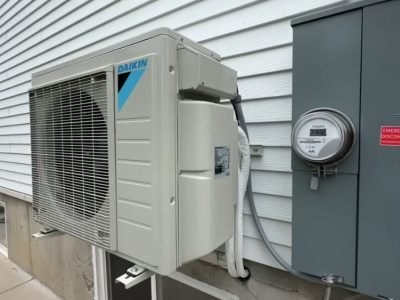 Outdoor Daikin mini split AC unit installed next to a home in Santa Clarita, CA, with electrical connections.