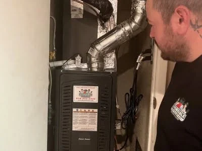 Affordable Heating and Air technician completing furnace installation and final inspection in Northridge CA.